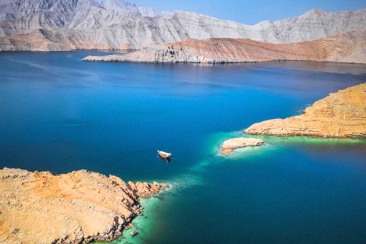 Mountains great for road trip in the UAE located in Musandam Oman overlooking the lake with a boat