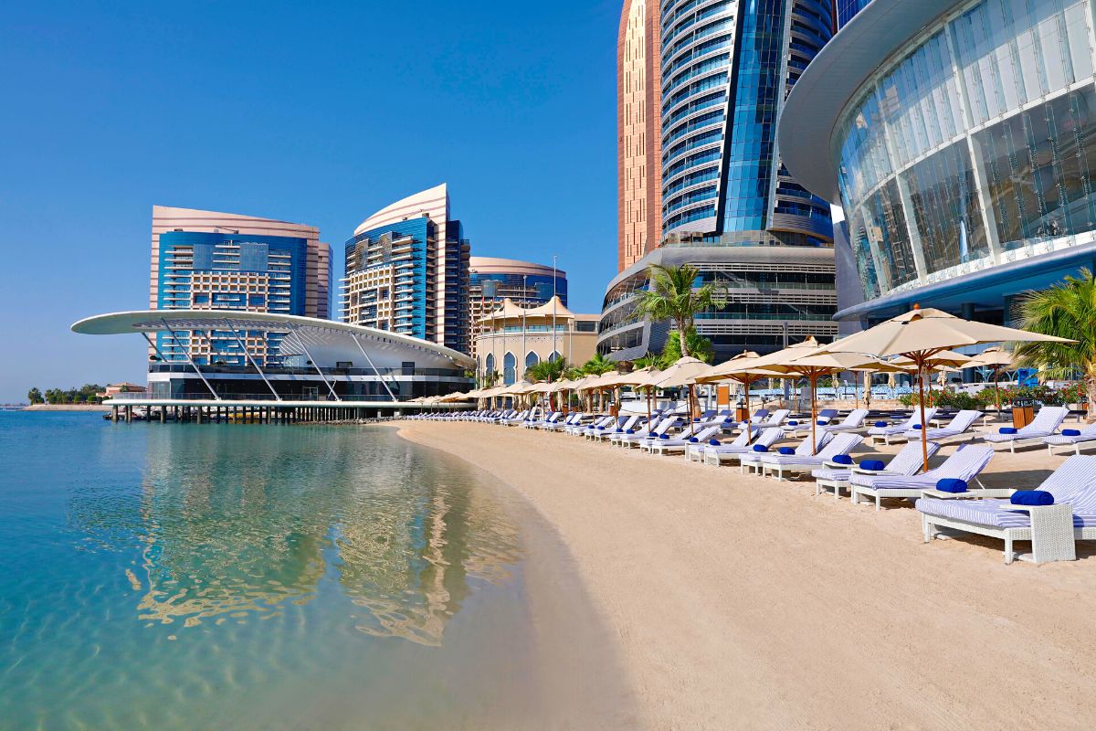 Conrad Abu Dhabi Etihad Towers pool side, with pool umbrellas, pool seats, staycaytion at Conrad Abu Dhabi Etihad Towers, an Abu Dhabi hotel