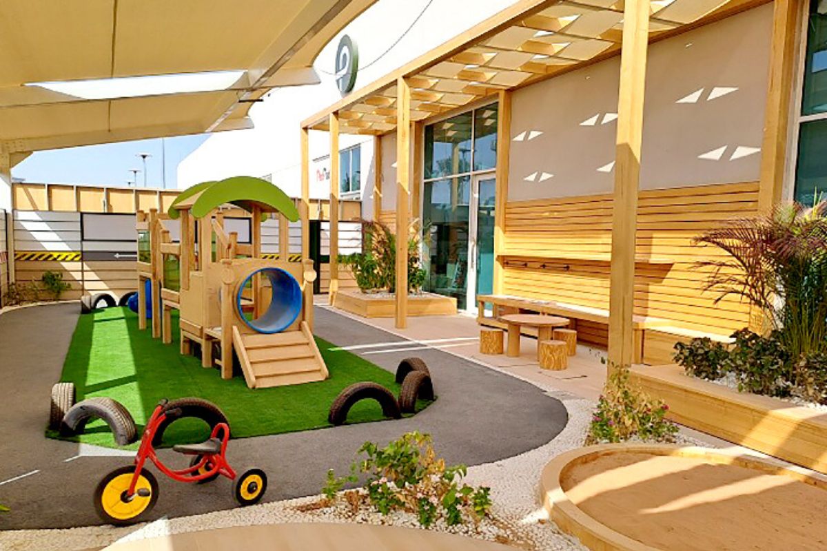 Playground with tricycle and slide at Redwood Montessori Nursery for best summer camps in Abu Dhabi