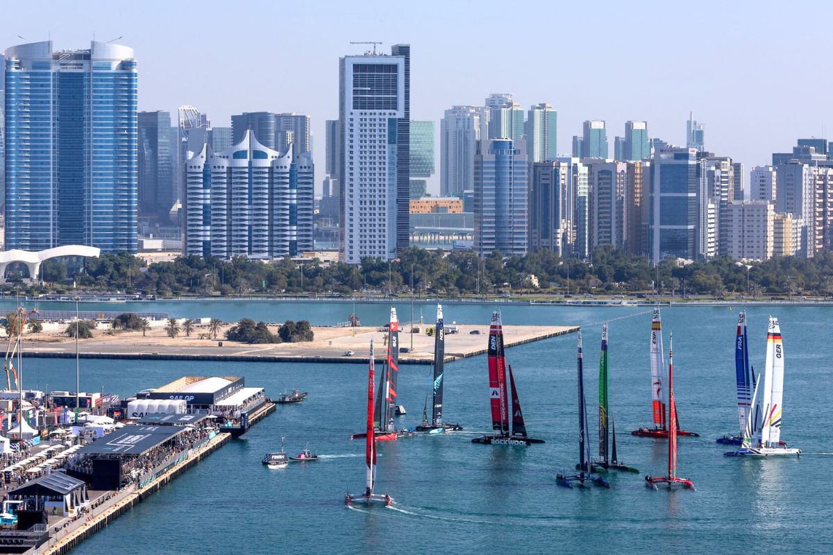 SailGP, SailGP 2024, Abu Dhabi Sail Grand Prix, Abu Dhabi Sail Grand Prix 2024, Image3-Peter Burling, Co-CEO and driver of New Zealand SailGP Team celebrates with the trophy on the podium, Image2-New Zealand SailGP Team helmed by Peter Burling celebrate victory in front of the SailGP Race Stadium, Image1-Aerial view of the SailGP F50 catamaran fleet passsing the SailGP Race Stadium on Race Day 2 of the Mubadala Abu Dhabi Sail Grand Prix presented by Abu Dhabi Sports Council, abu dhabi sports council, abu dhabi sports council 2024, mubadala, mubadala sports 2024, mubadala 2024