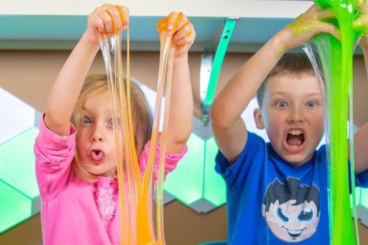 2 kids playing with slime at Yas Acres Golf and Country Club for their summer offers this 2024