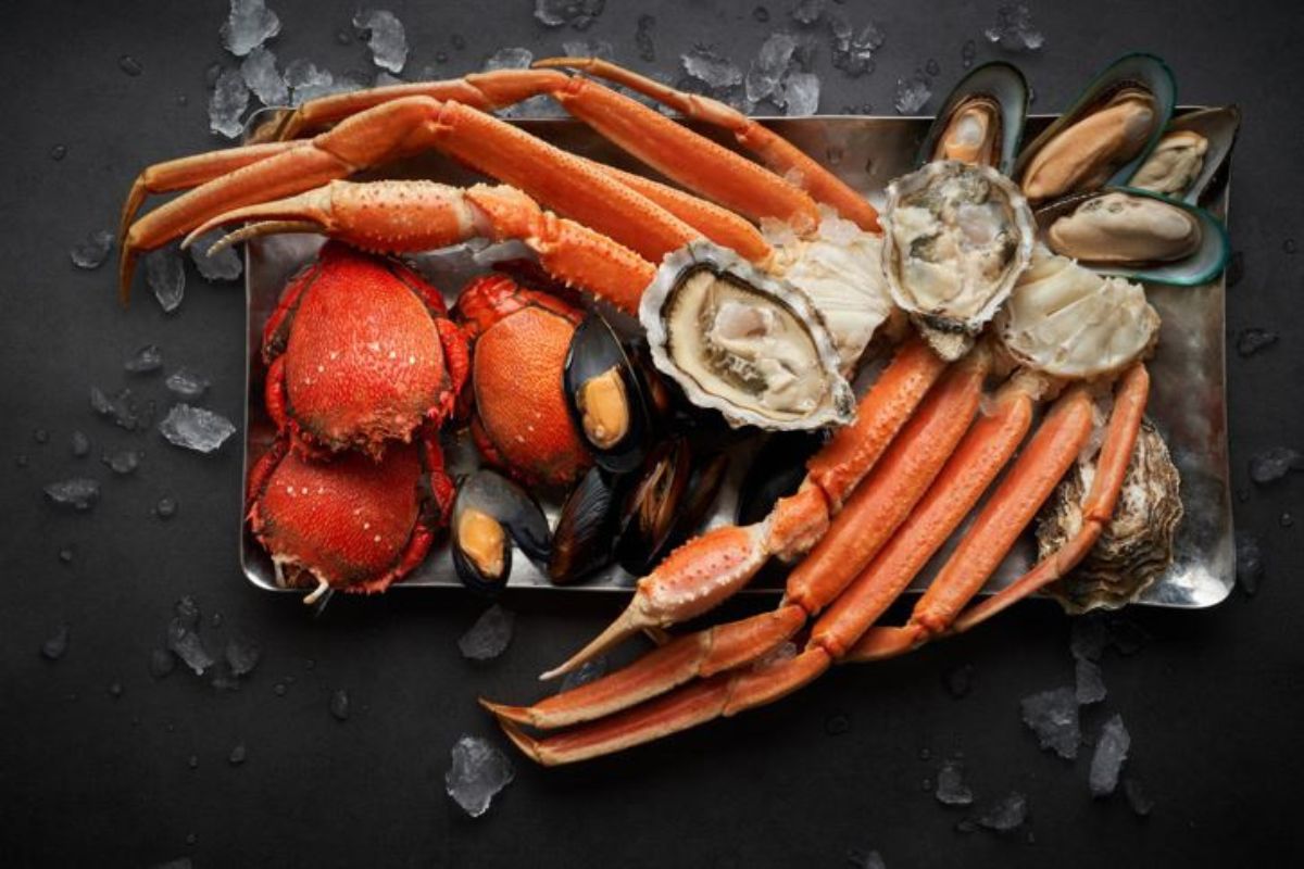 Fresh seafood consists of king crab legs with fresh oysters and mussels chilled and plated at Olea's Shells and Crabs at The St. Regis Saadiyat Island Resort