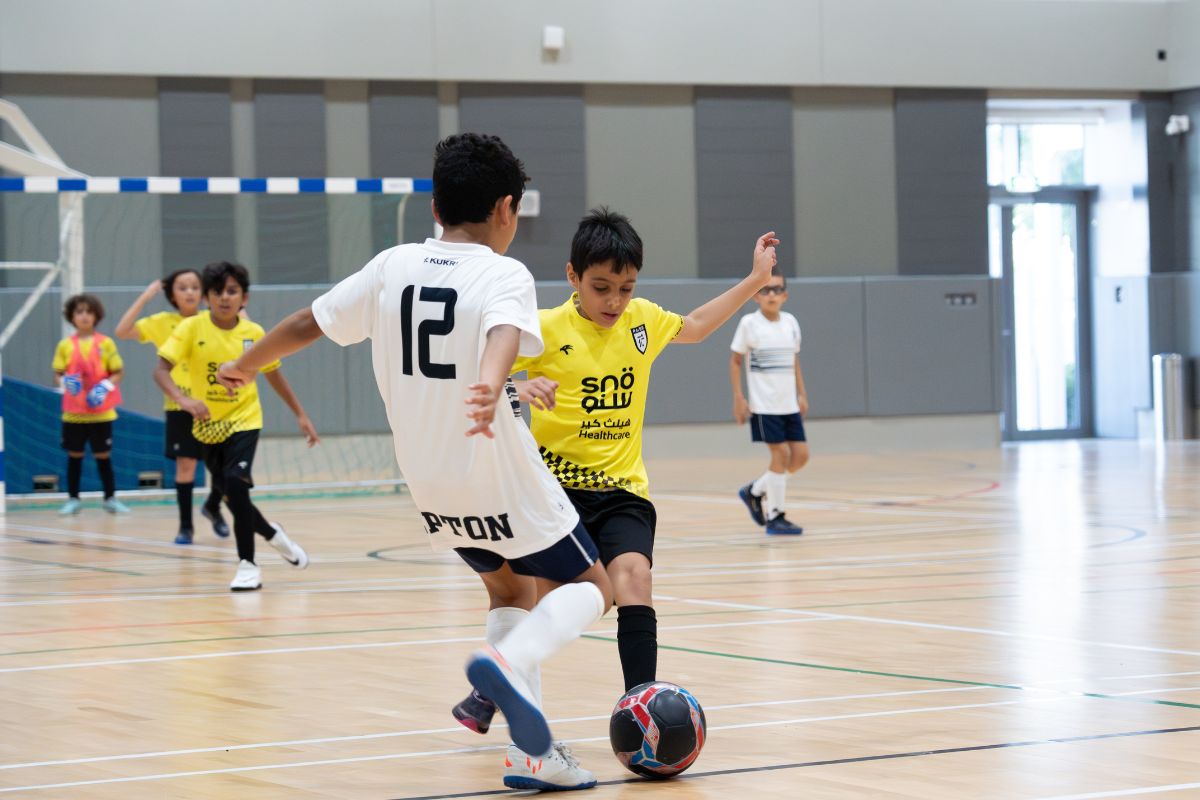 Kids from the opposing team battling it out playing football at Abu Dhabi futsal leagues finals this weekend