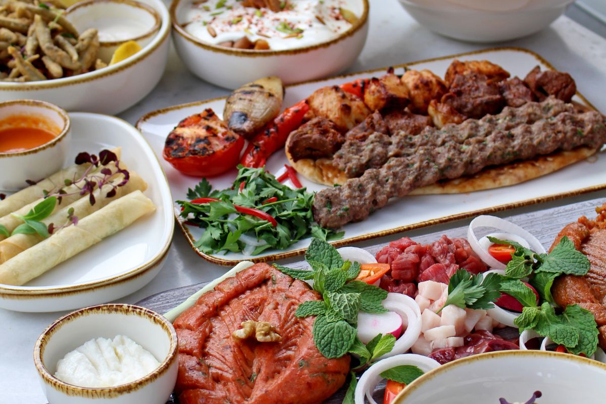 A table full of assorted Arabic dishes at Fairmont Bab Al Bahr for their dining offers this Eid Al Adha