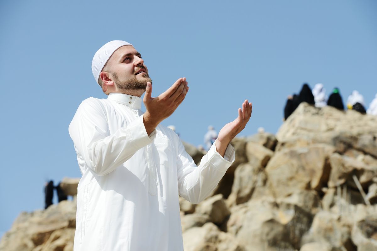 A muslim guy praying for Arafat and Eid Al Adha UAE public holiday