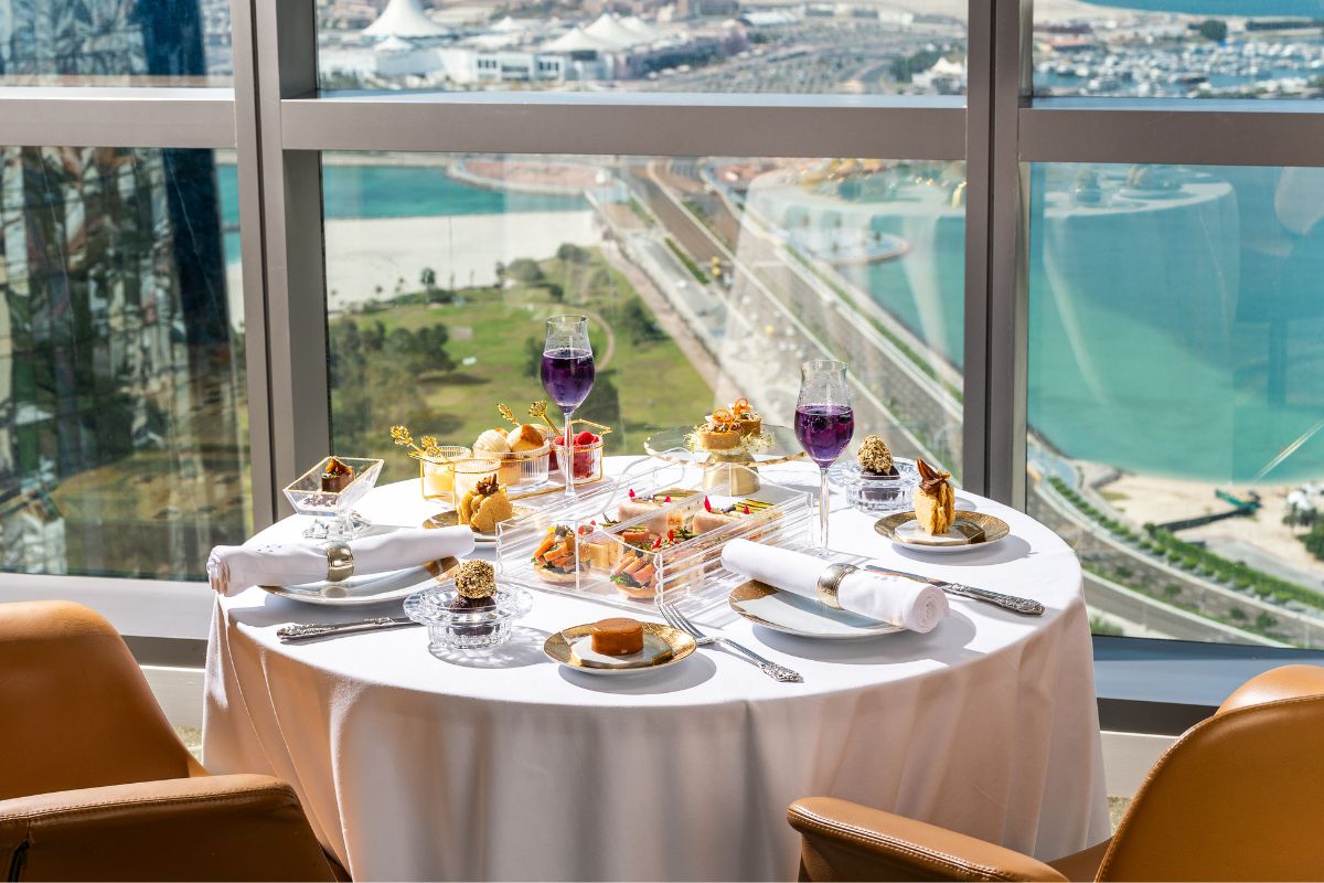 A table of afternoon tea with scones, sandwiches, cakes at Level 45 at Conrad Abu Dhabi Etihad Towers