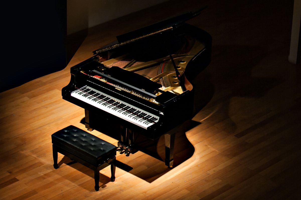 Grand piano with chair in a dark place for Saif the pianist
