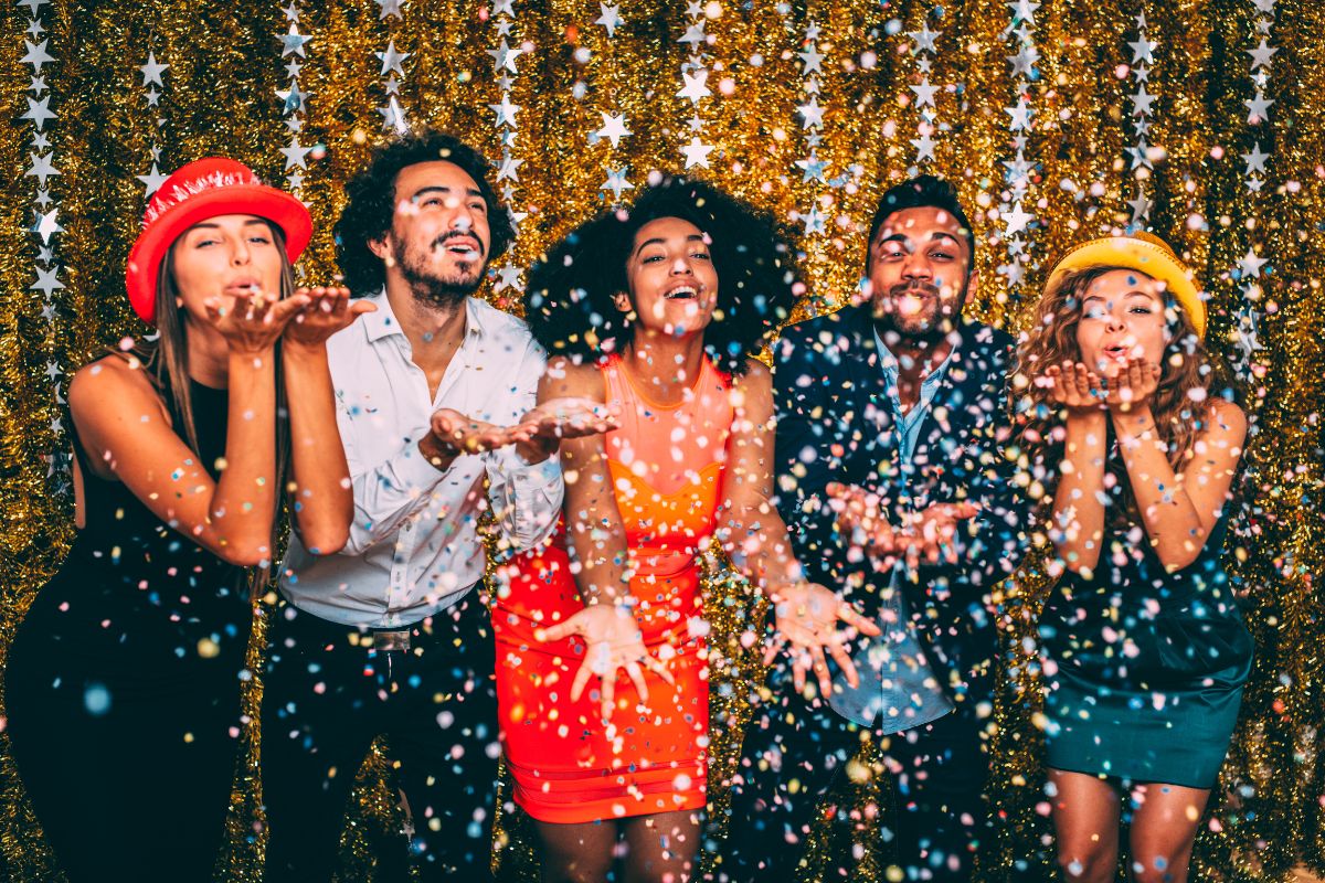 Friends celebrating new years with confetti and decorations for UAE public holiday 2025