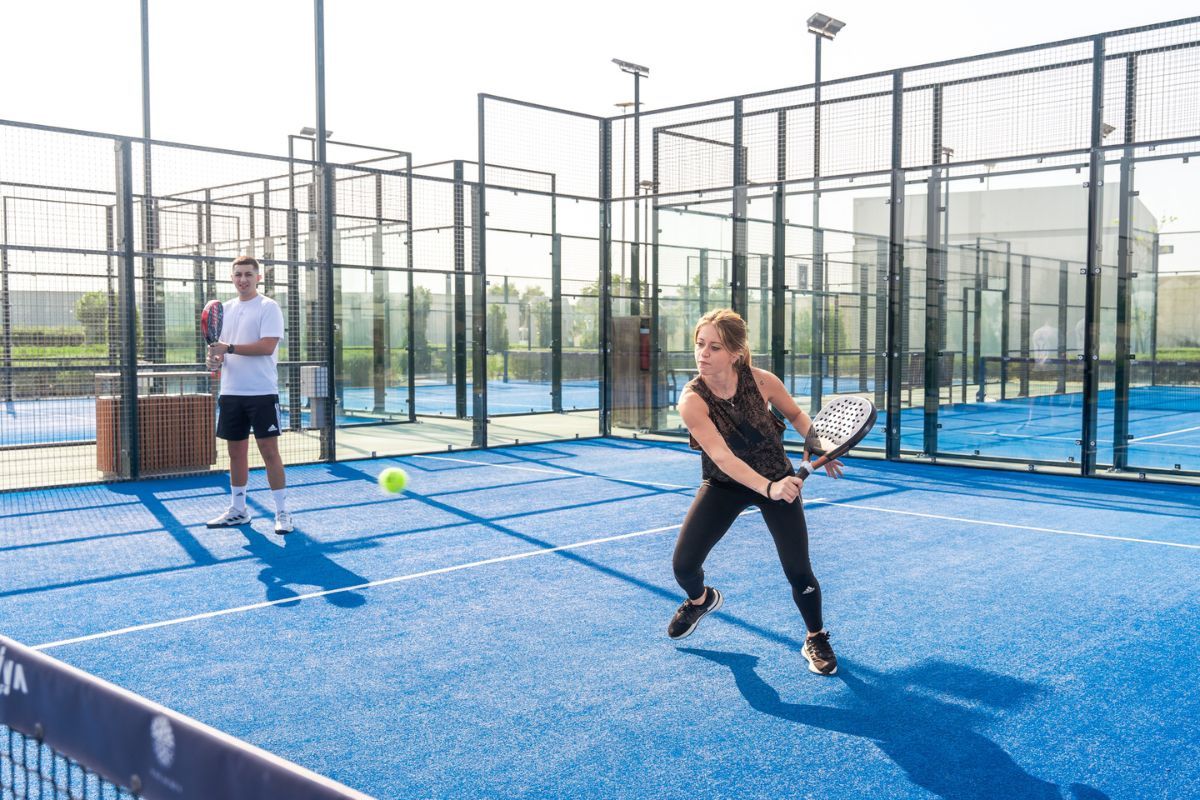 A couple playing pickleball at Yas Acres Golf and Country Club membership