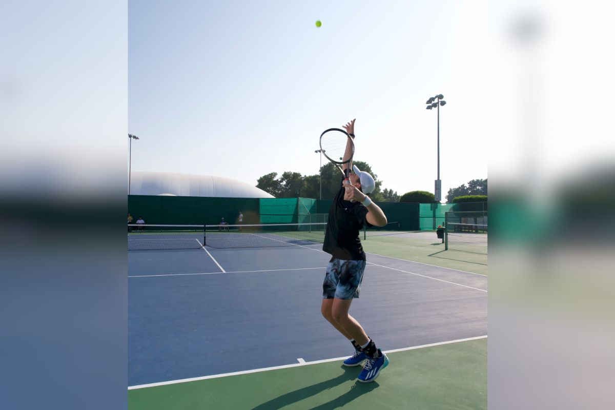 Tudor Zecheru, a rising tennis star in Abu Dhabi, serving a tennis ball