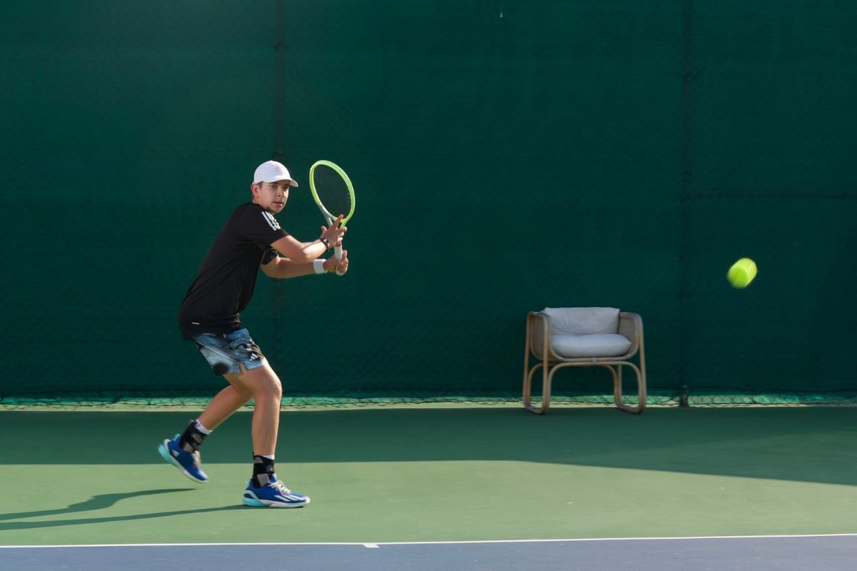 Tudor Zecheru, a rising tennis star in Abu Dhabi, receiving and playing tennis