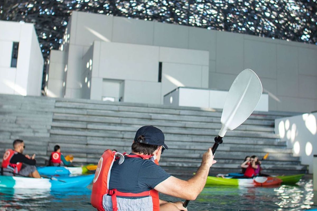 People kayaking at Louvre Abu Dhabi for things to do