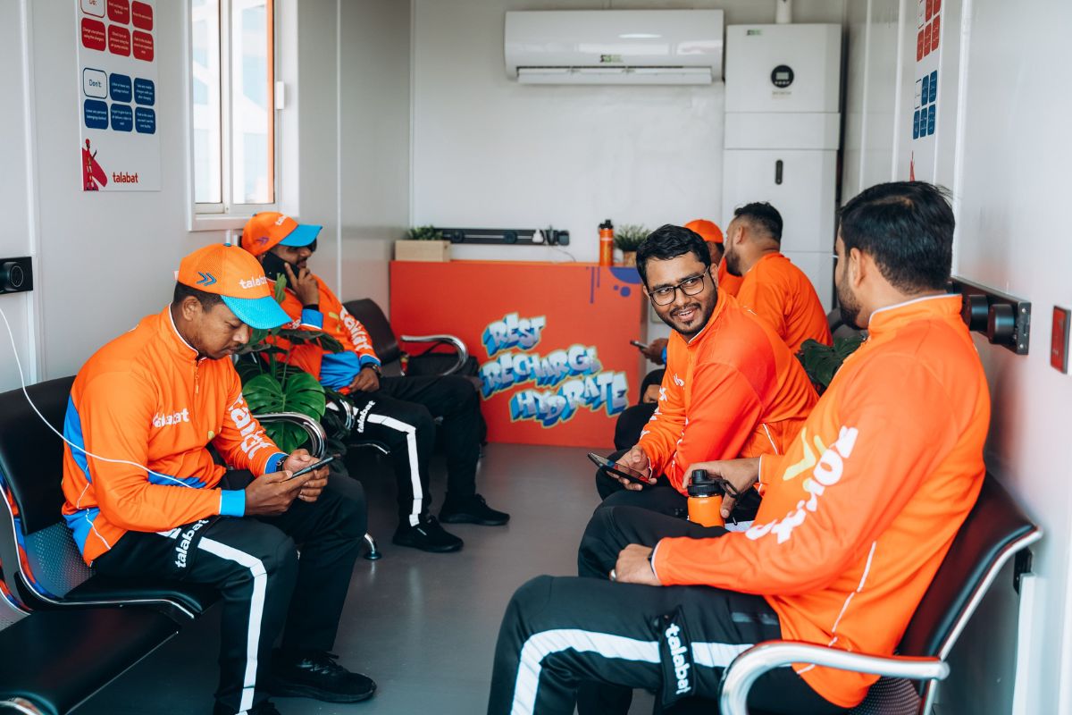 Talabat drivers inside a rest area provided by malls in Abu Dhabi to beat the heat this summer, it also shows a functioning air conditioner, sitting area, charging plug outlets and more for the comfortability of the riders