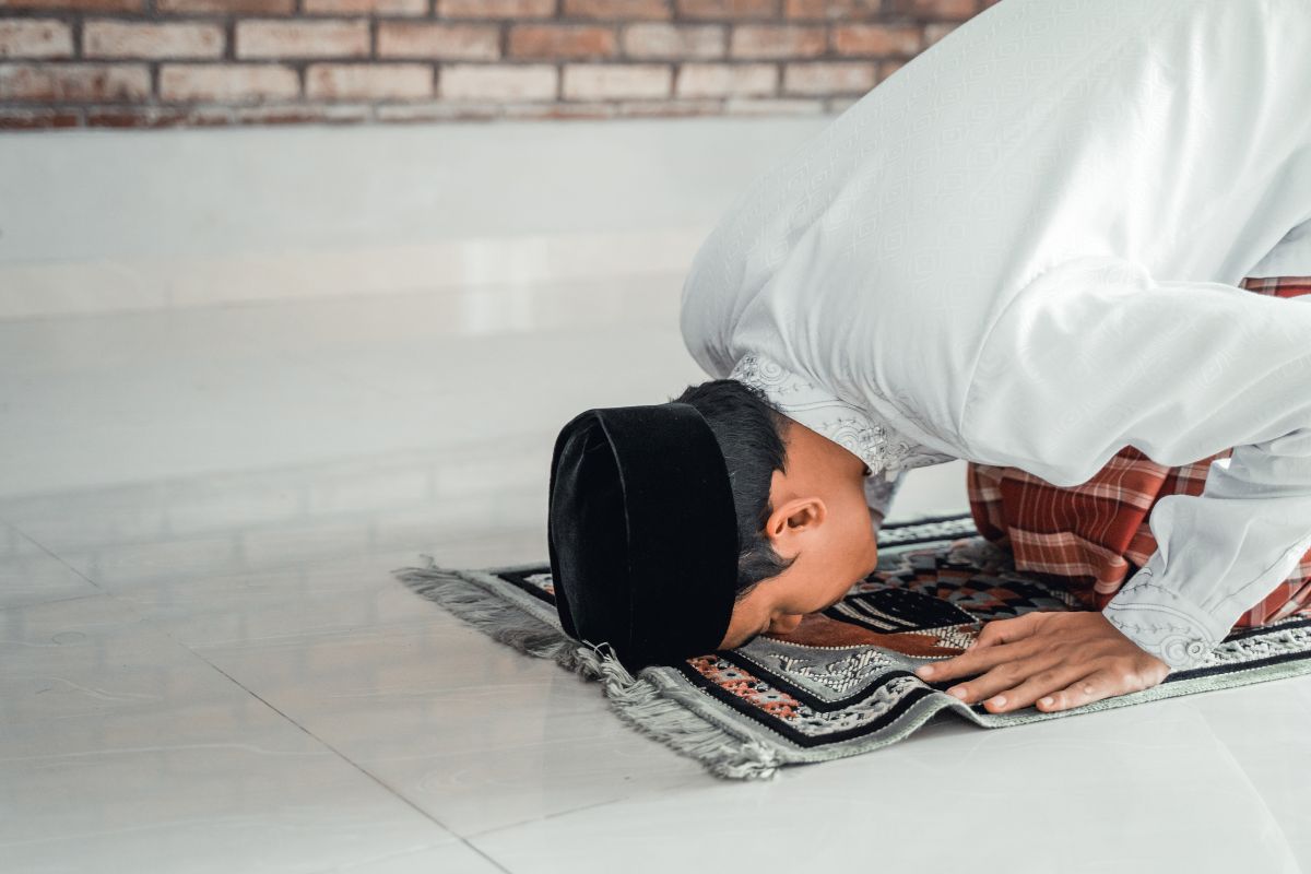 A Muslim man praying at the Sheikh Zayed Grand Mosque in Abu Dhabi