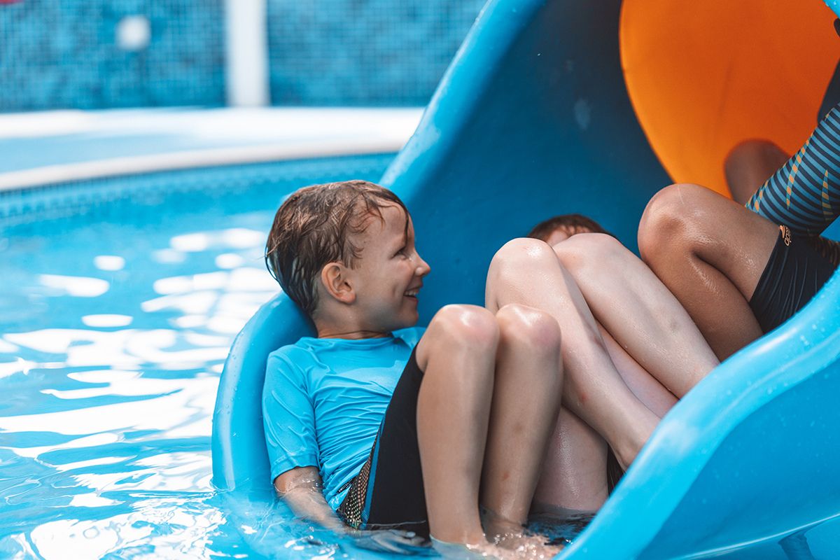 The Club Abu Dhabi summer camp kids on a slide