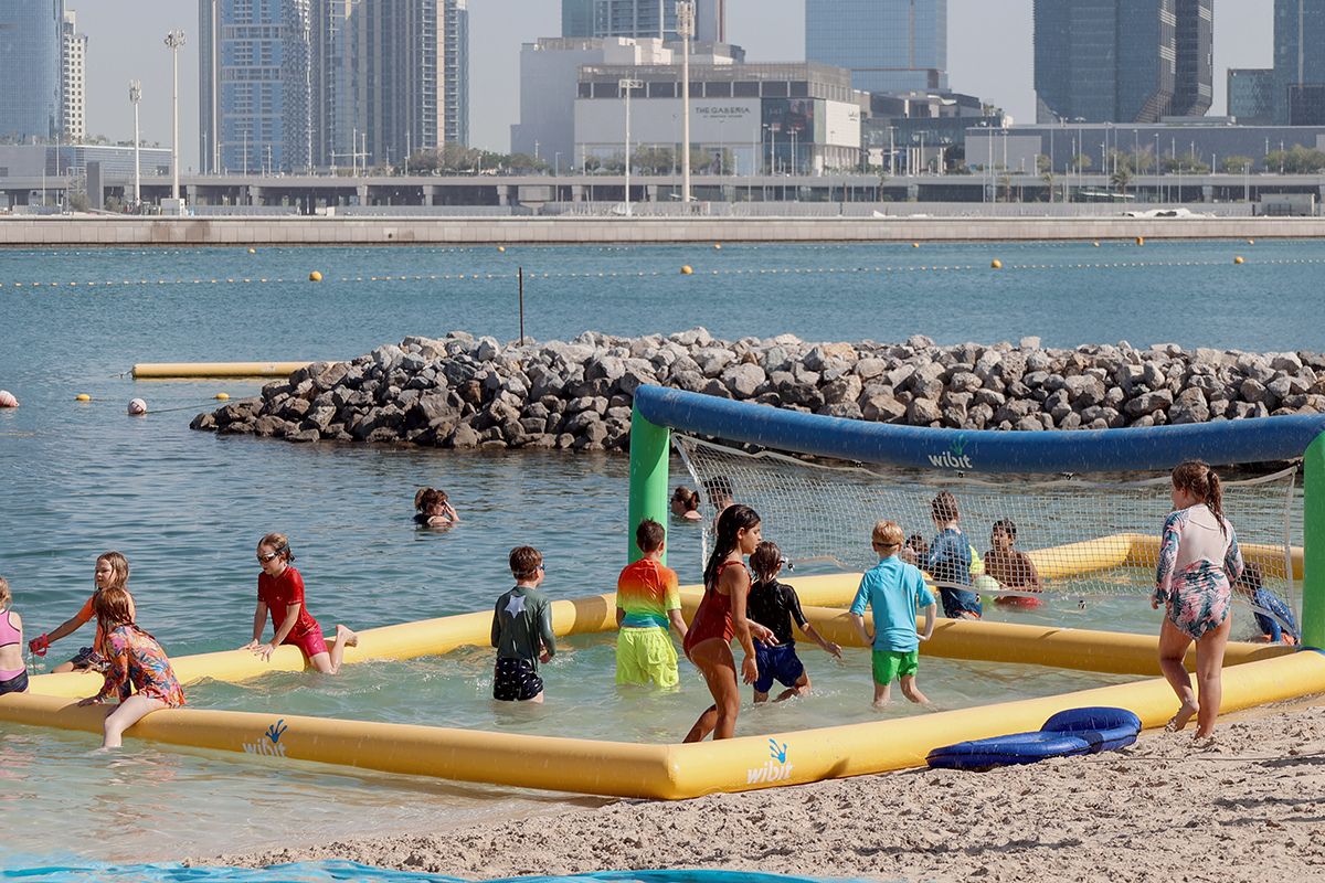 The Club Abu Dhabi summer camp kids playing at the beach