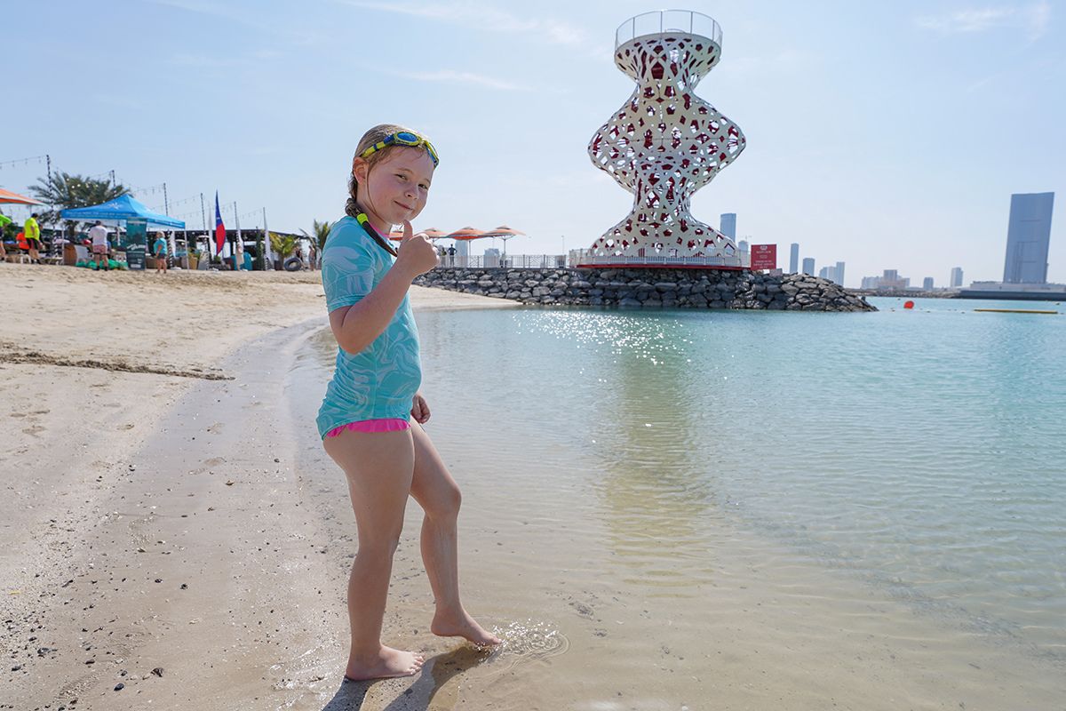 A kid at the beach for The Club summer camp