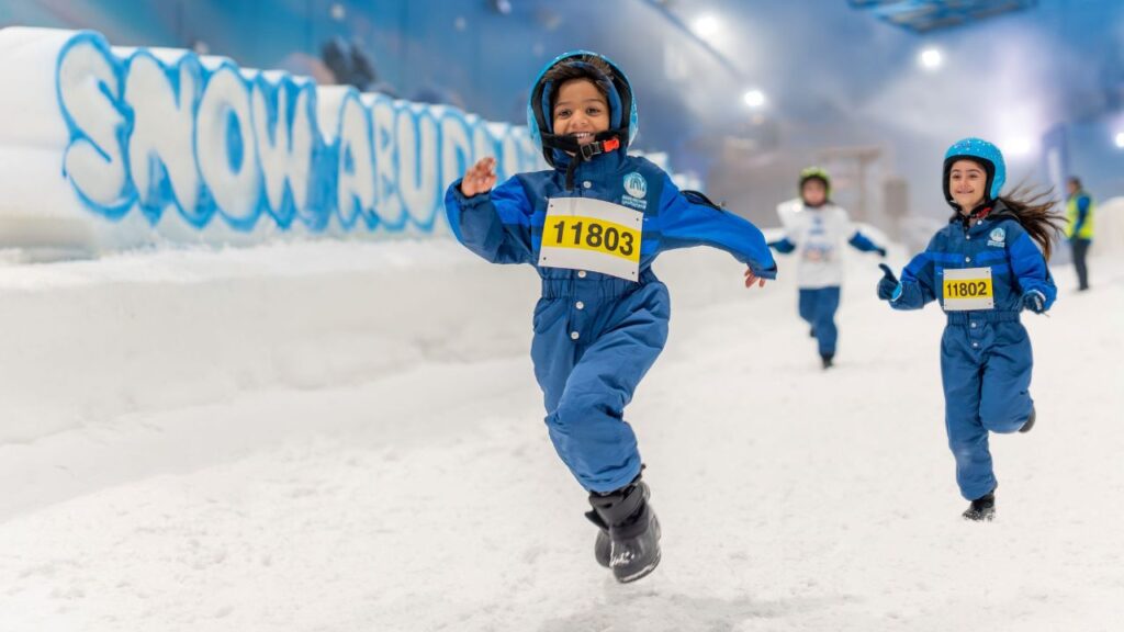 kids playing in the snow at snow abu dhabi