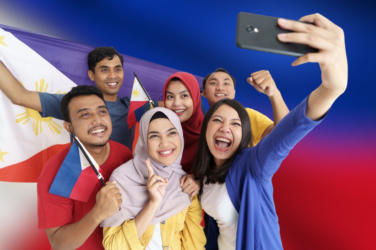 Filipinos taking a selfie with the Philippine flag