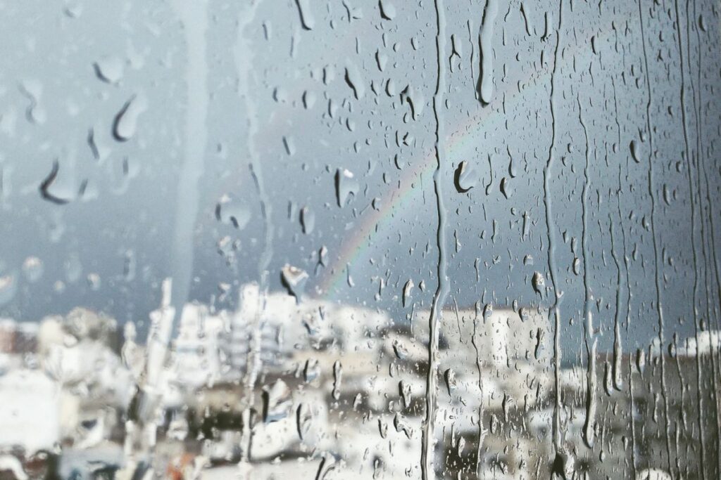 Droplets of rain on a window indicating a gloomy weather in the UAE