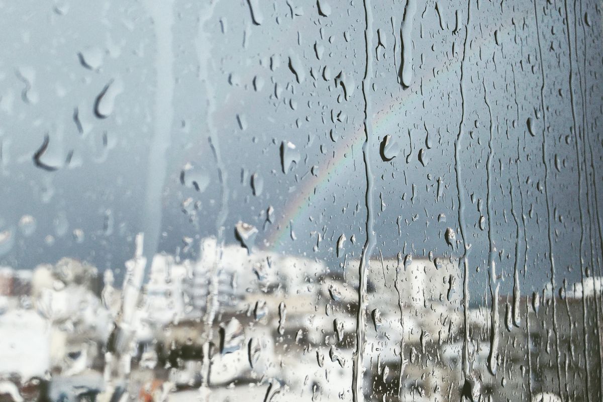 Droplets of rain on a window indicating a gloomy weather in the UAE