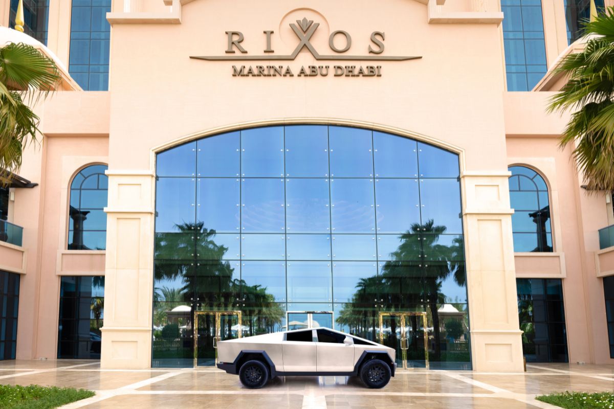 Rixos Marina Abu Dhabi with a Tesla Cybertruck parked in front, win a two night stay and test drive a Tesla Cybertruck