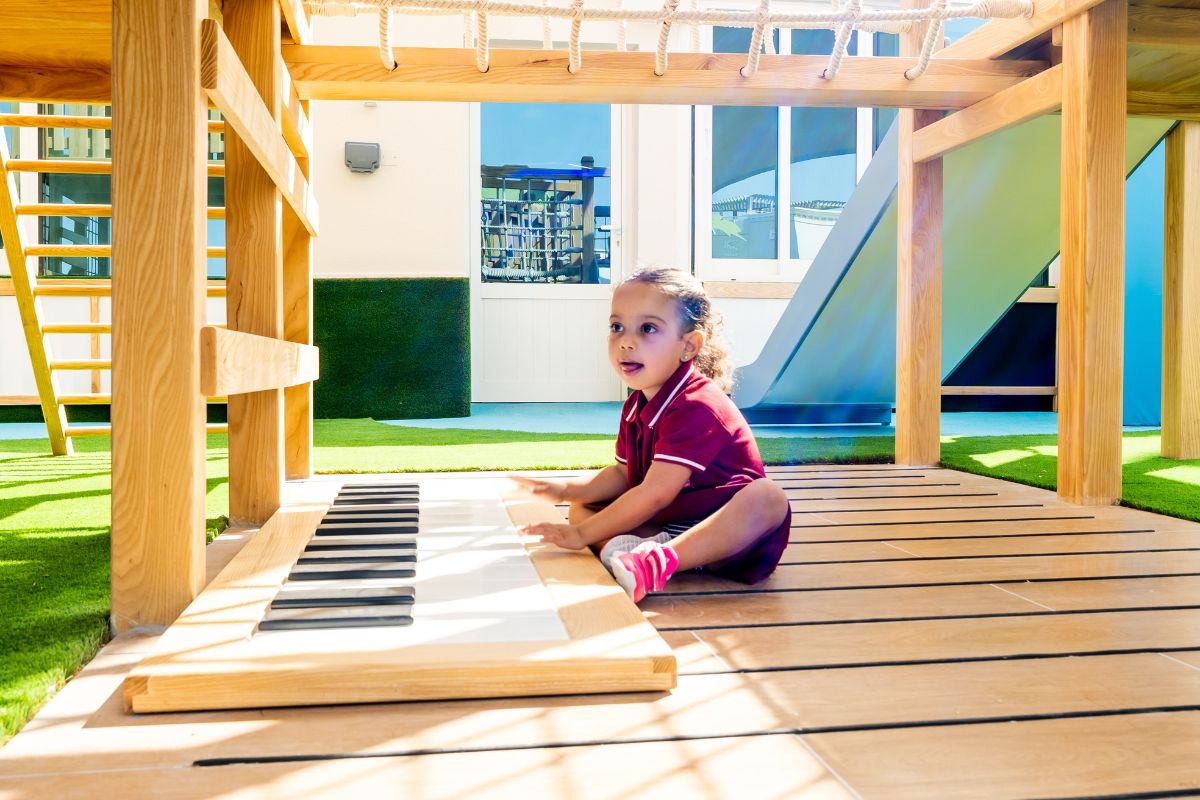 A kid on the playground at The Redwood Montessori Nursery