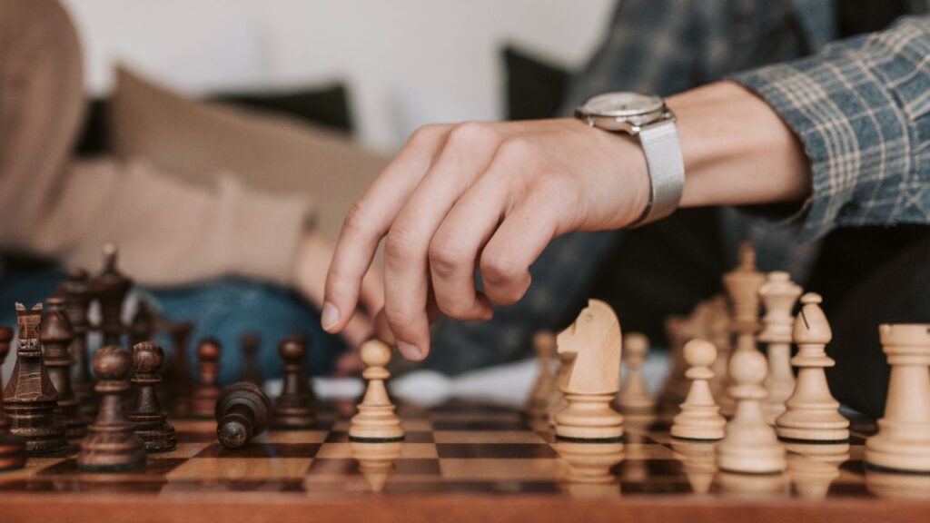 A hand playing chess
