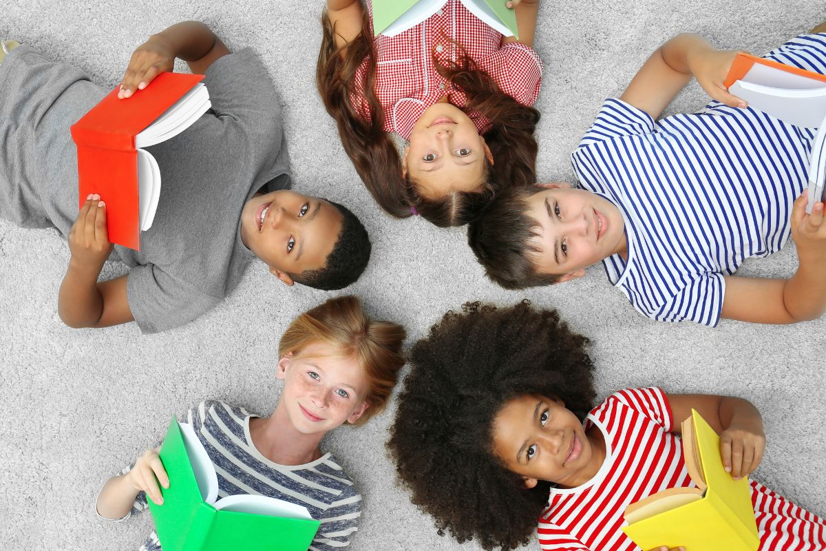 Children holding books in a circle for International Literacy Day