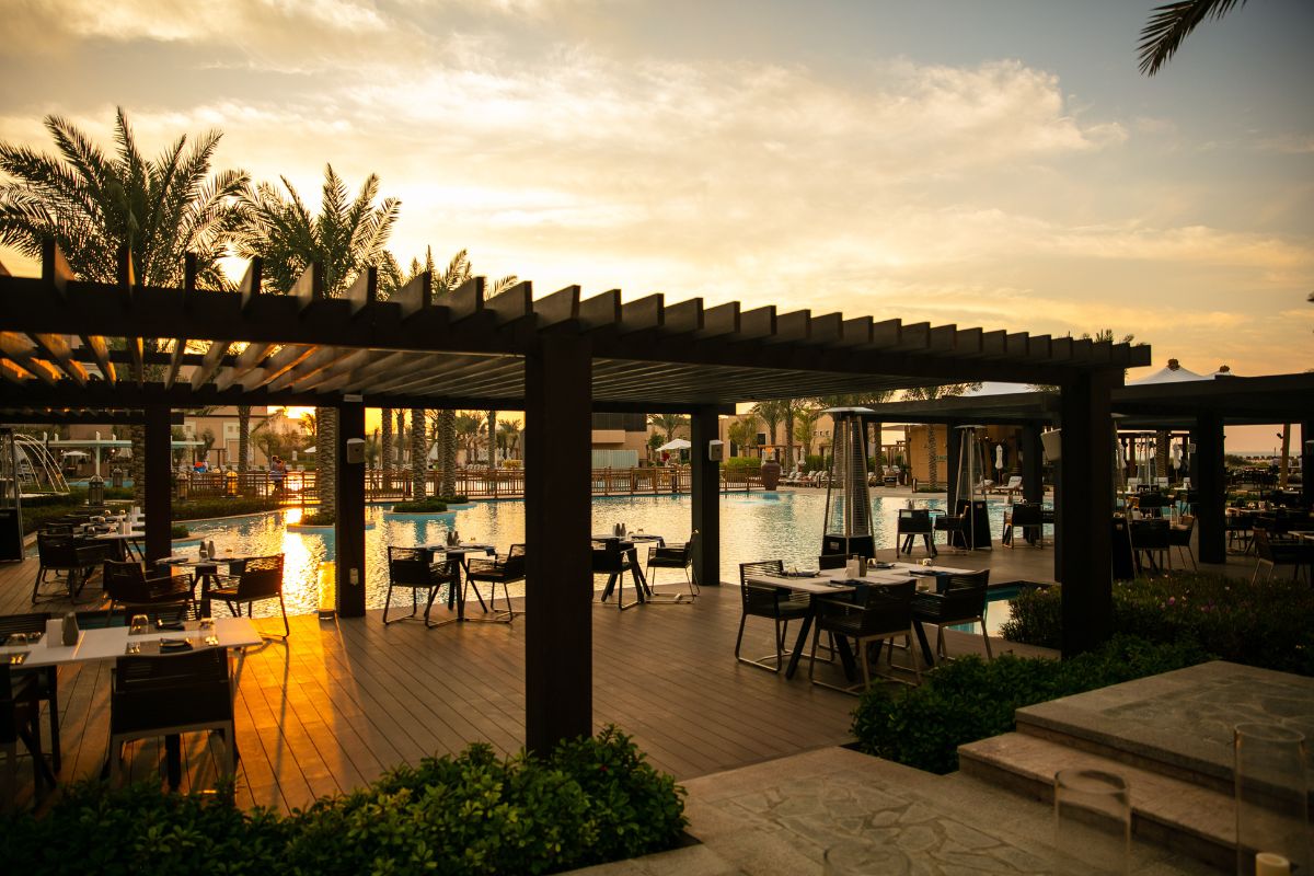 Turtle Bay at Saadiyat Rotana Resorts and Villas outdoor seating with a stunning sunset view