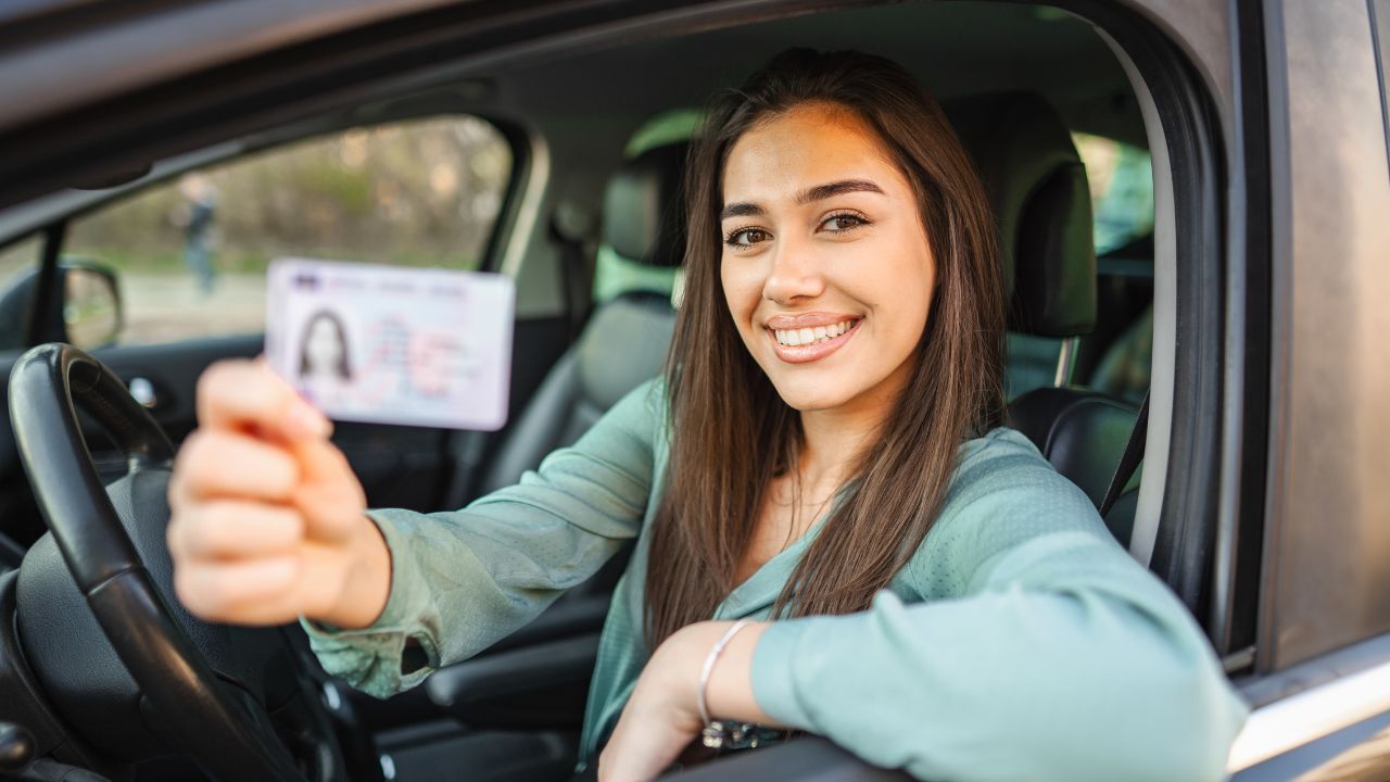 girl smiling with her drivers license