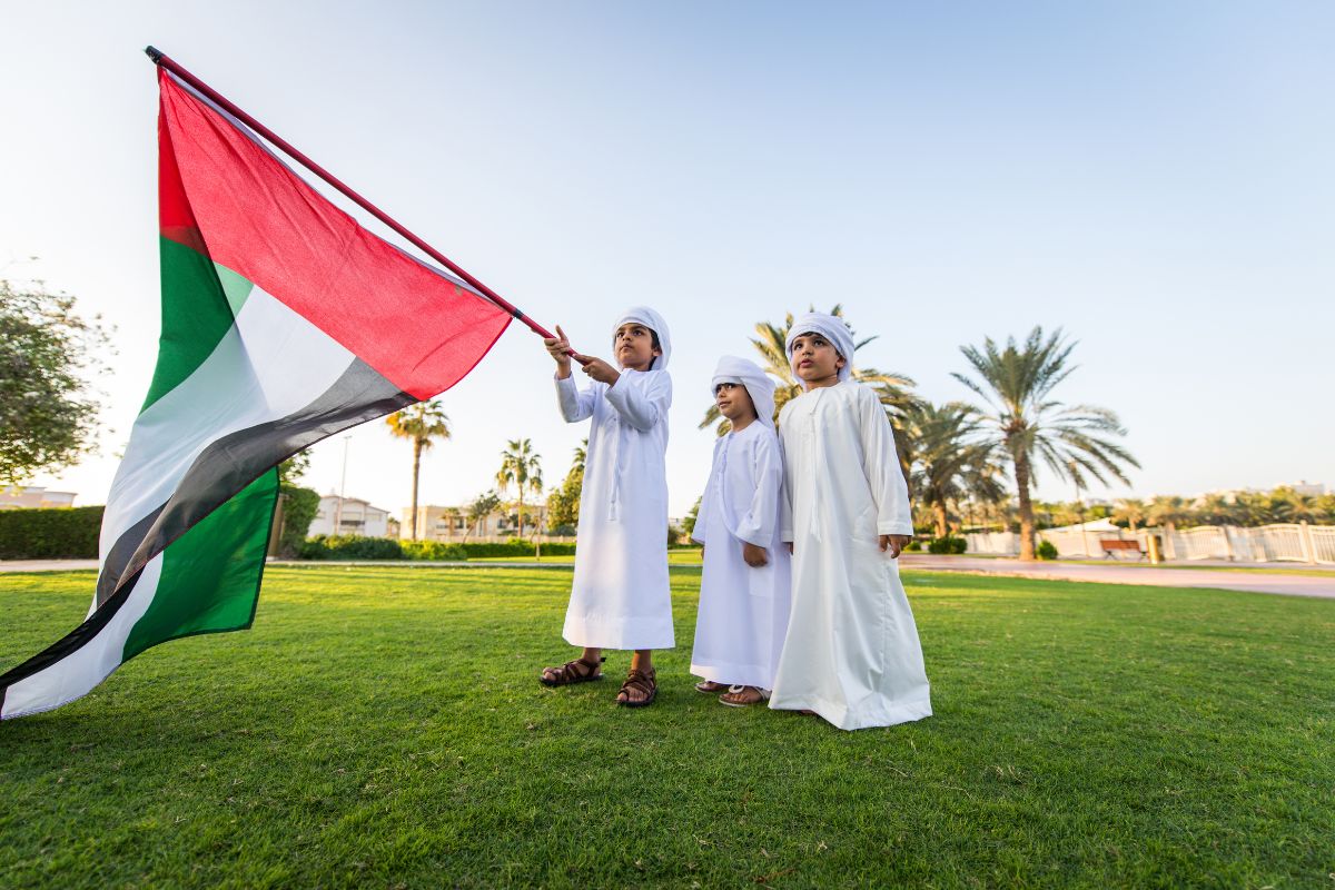 Uae Emirati Kids Holding A Uae Flag