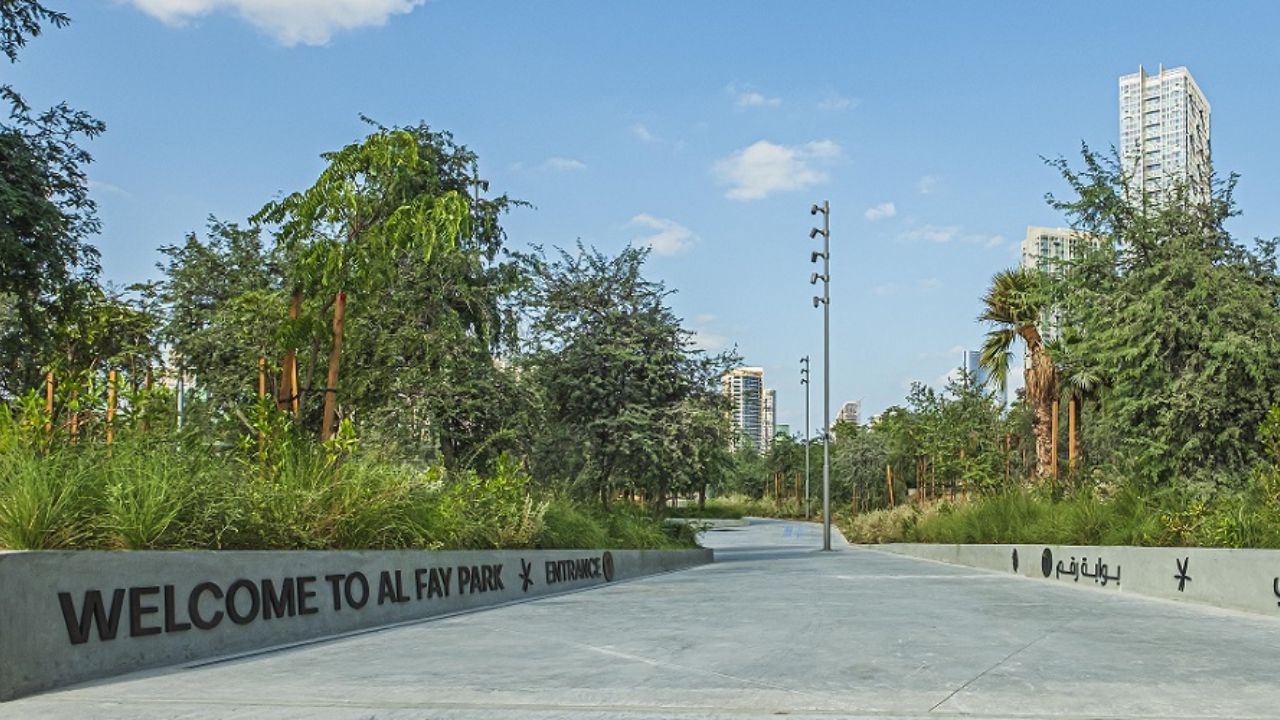 A walkway with trees and plants at al fay park abu dhabi