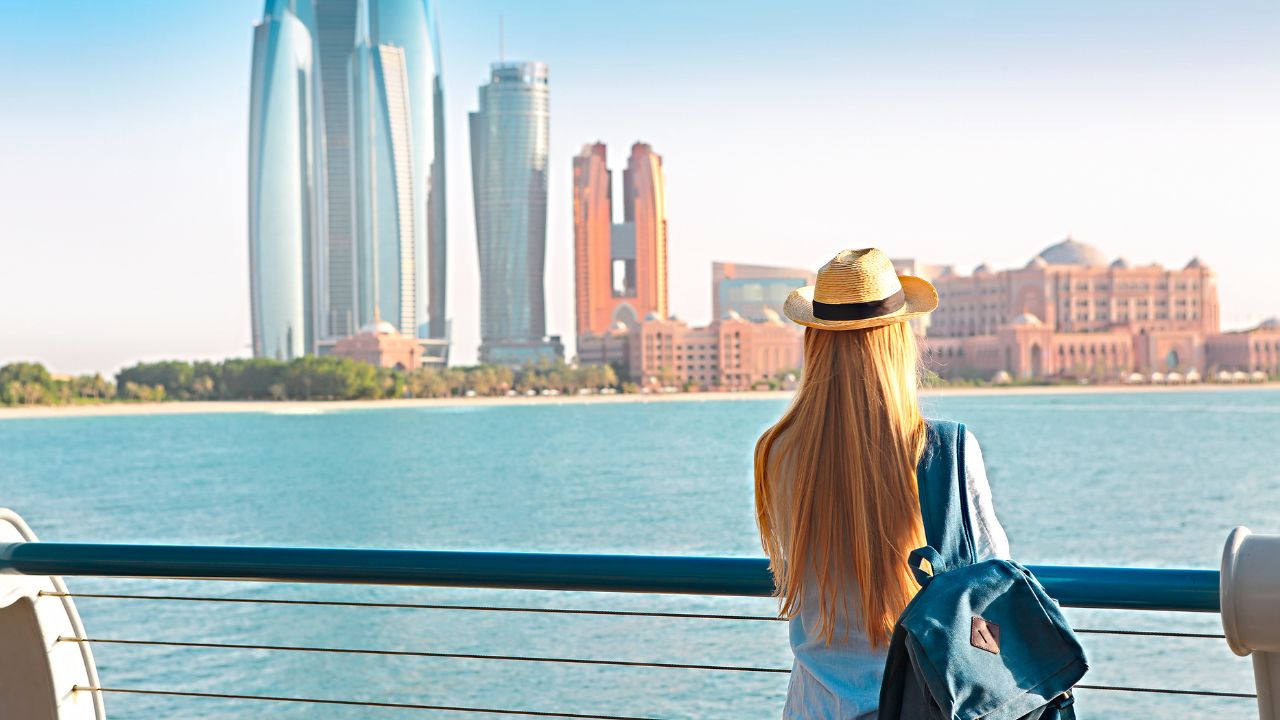 girl in corniche looking at the view in front of her abu dhabi city