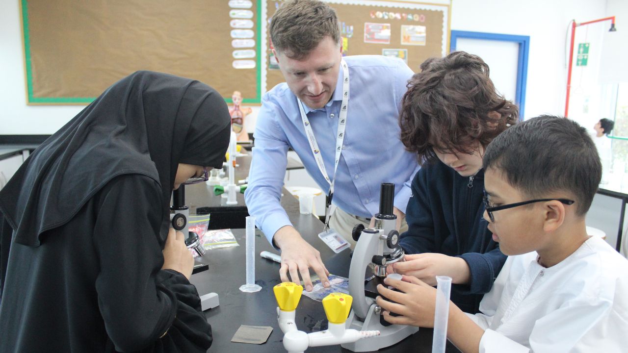 al shohub private school abu dhabi students with their teacher