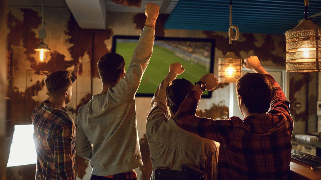 group of friends watching game in a sports bar