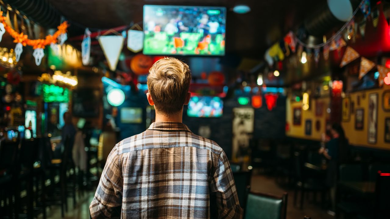 guy watching game in a sports bar