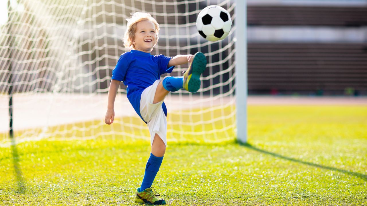 Kid playing football on the field