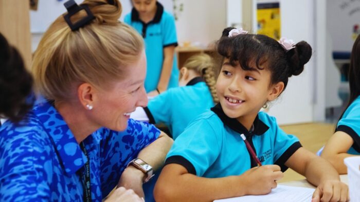 the british international school abu dhabi teacher smiling at student