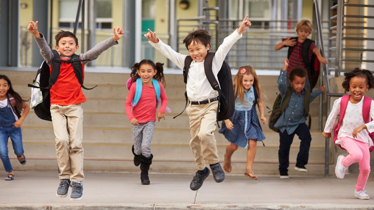 happy students leaving school