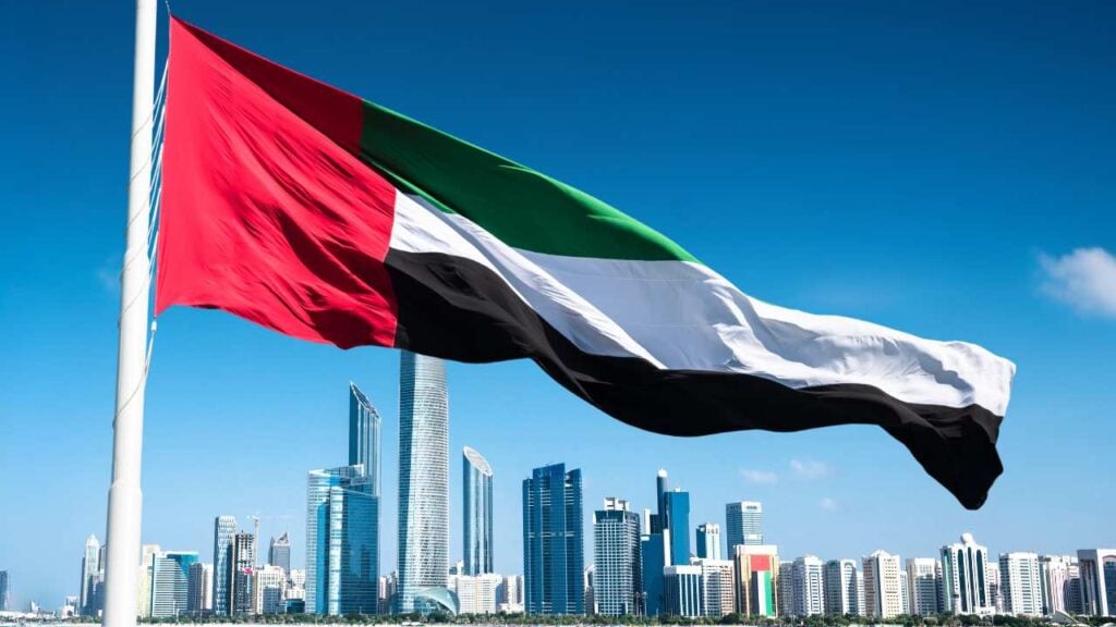 united arab emirates flag with abu dhabi city a background
