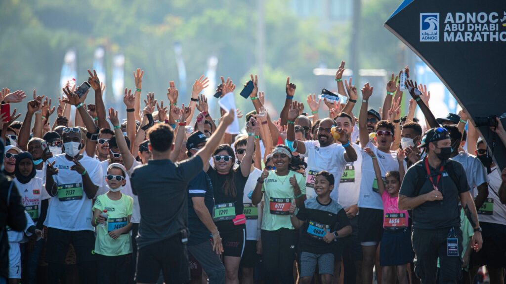 Yalla Abu Dhabi Life - Marathon participants celebrating at the start line.