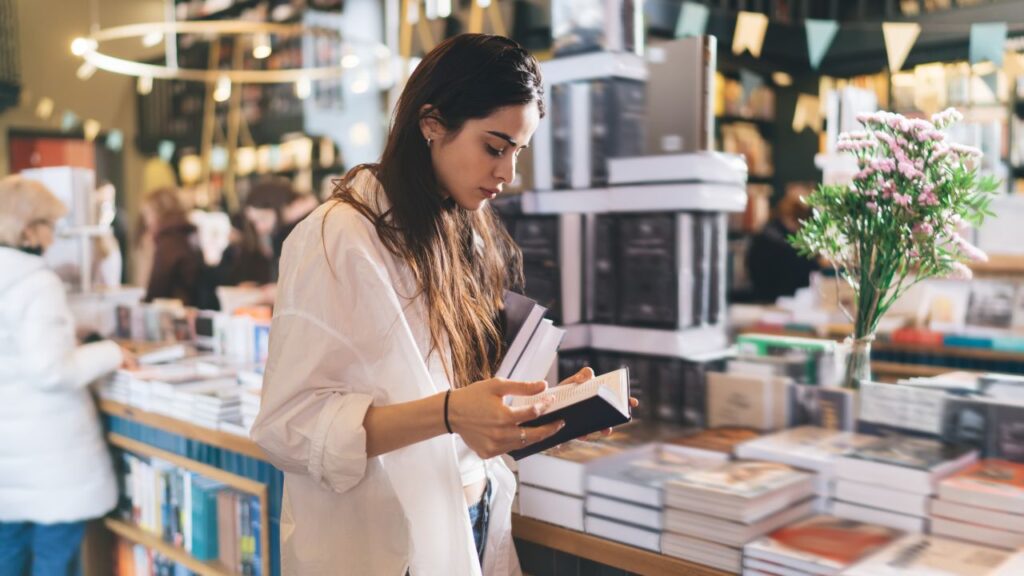 Woman Browsing Books at a Bookstore During Daytime