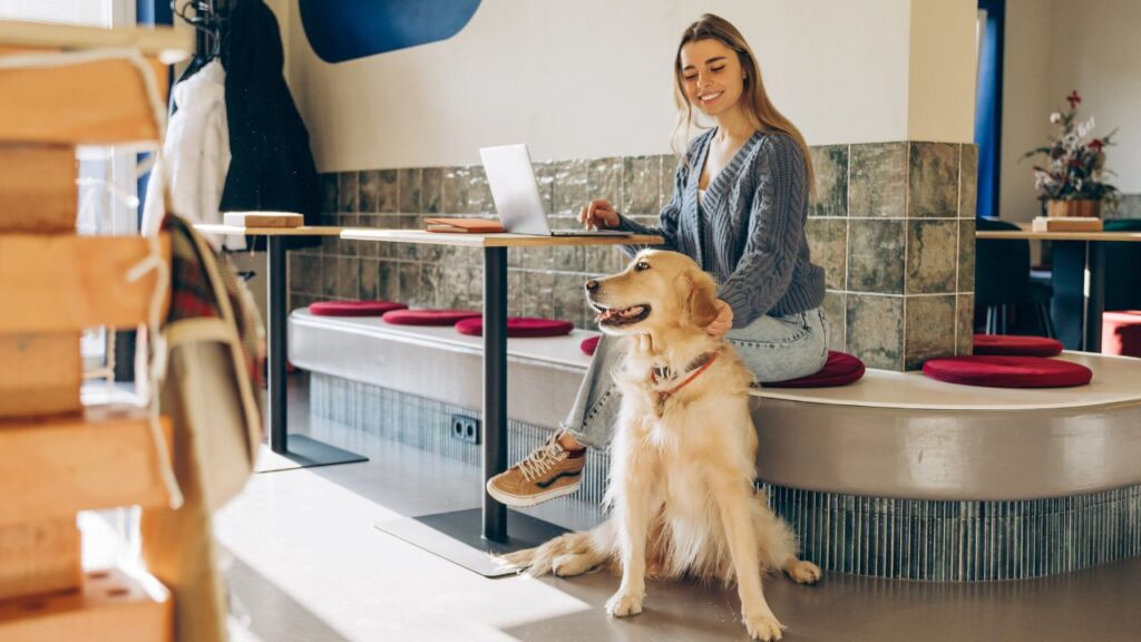 Pet-friendly café in Abu Dhabi with woman and dog, perfect for relaxing with your furry friend.