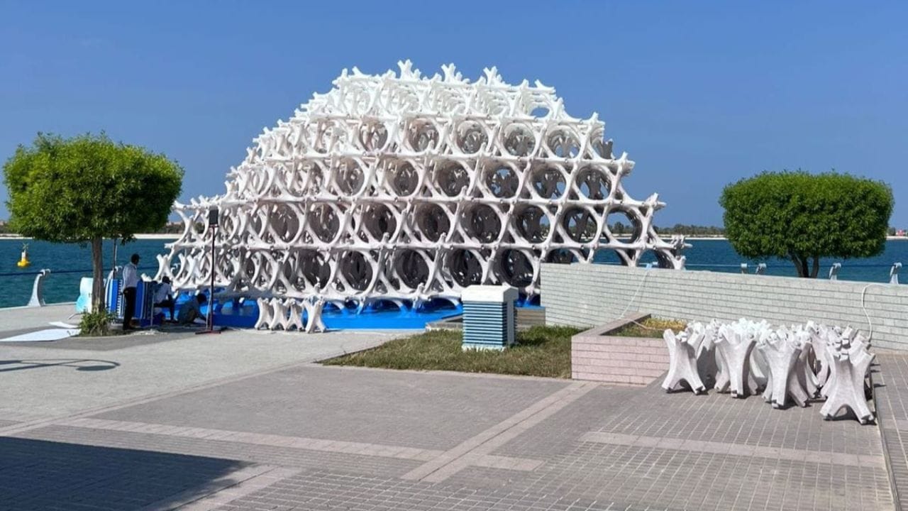 Large white spherical art installation by the water in Abu Dhabi.