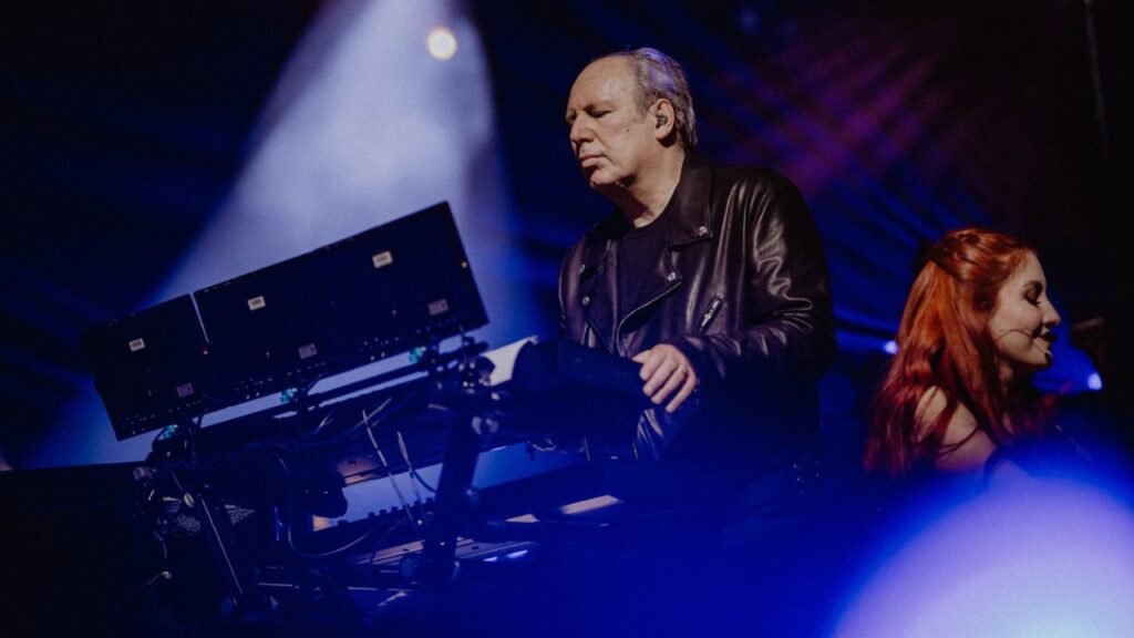 Musician performing with electronic equipment.