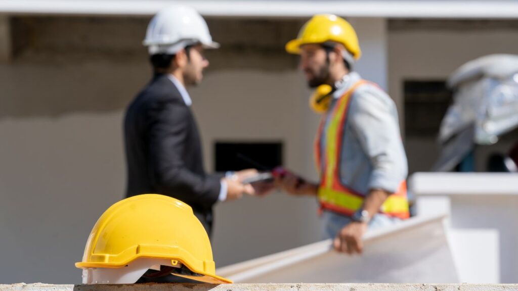 people shaking hands with helmet
