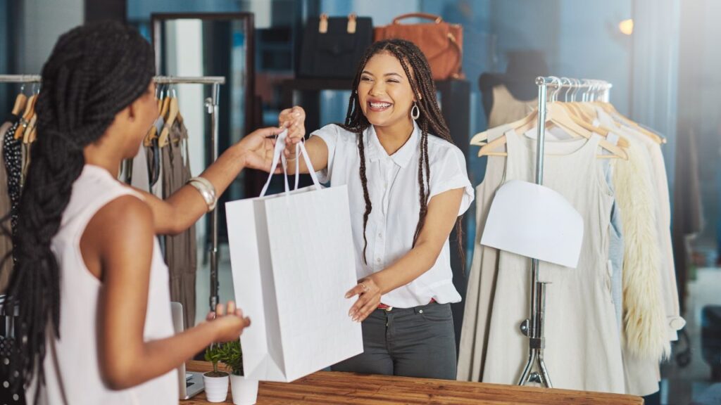 lady handing a bag to another lady