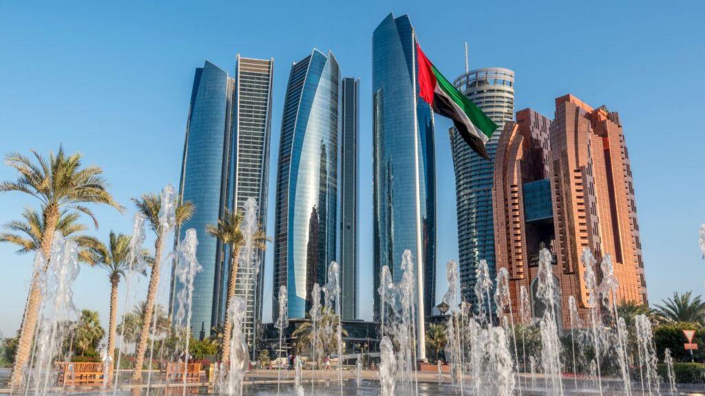 image of abu dhabi building with flag and fountain