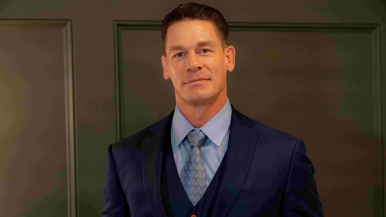 male actor/wrestler john cena smiling wearing a suit